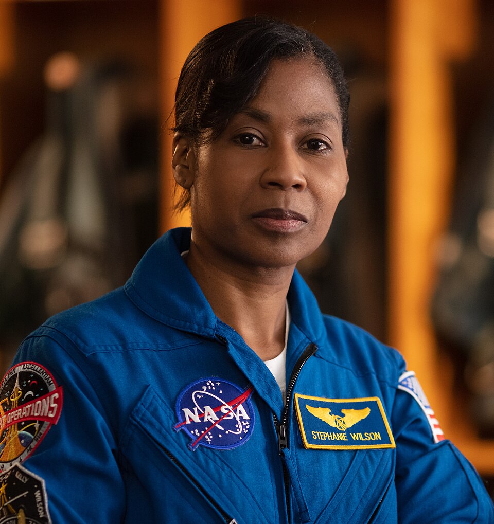 Stephanie Wilson in a blue NASA flight jacket